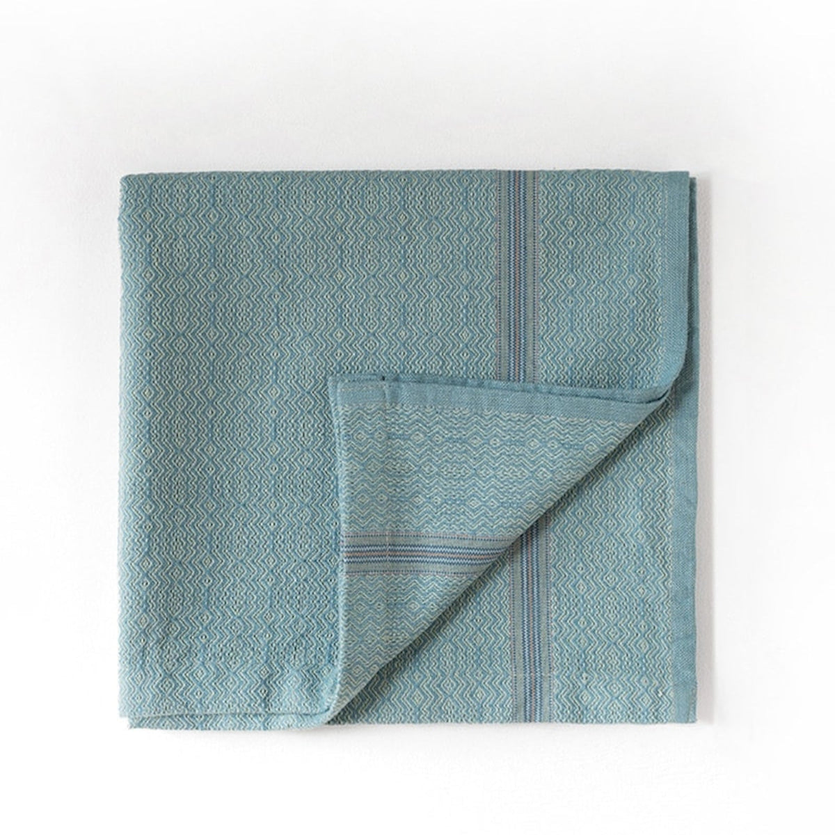 Mint towel with geometric pattern on a white background