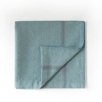 Mint towel with geometric pattern on a white background
