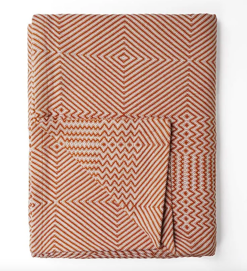 Folded fabric with geometric pattern on a white background