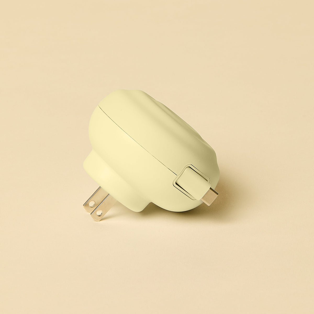 Light yellow wall adapter on a beige background