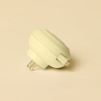 Light yellow wall adapter on a beige background