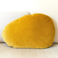 Mustard yellow pillow on a beige sofa