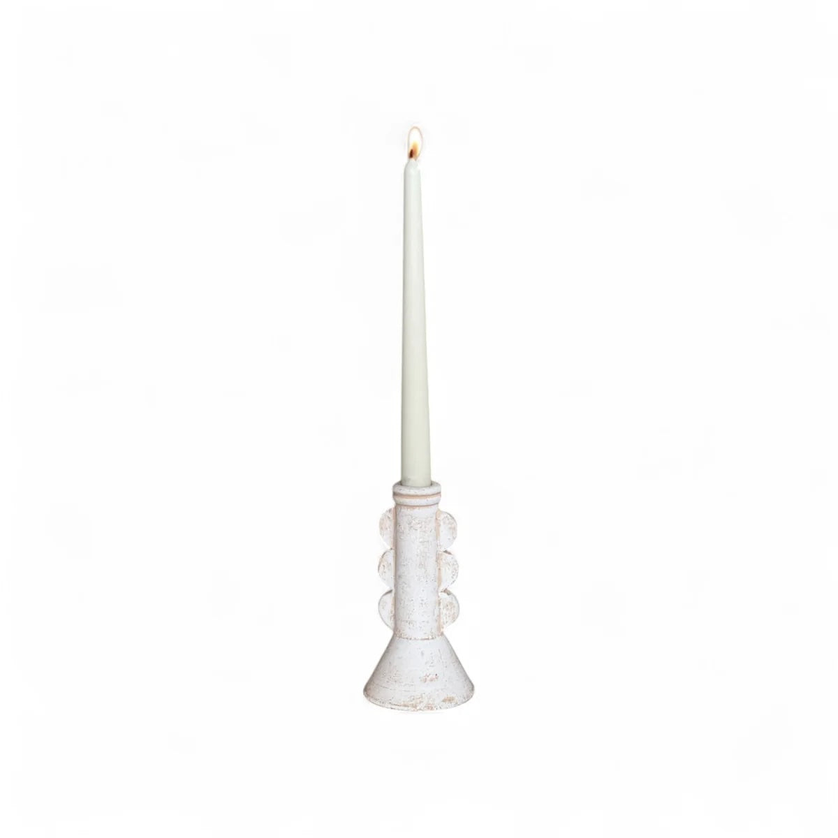 White candle holder with a lit white candle on a white background