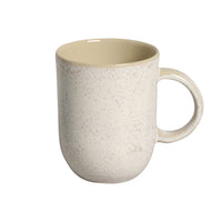 Speckled beige mug on a white background
