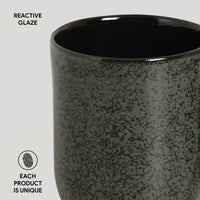 Ceramic mug with reactive glaze finish on a light gray background