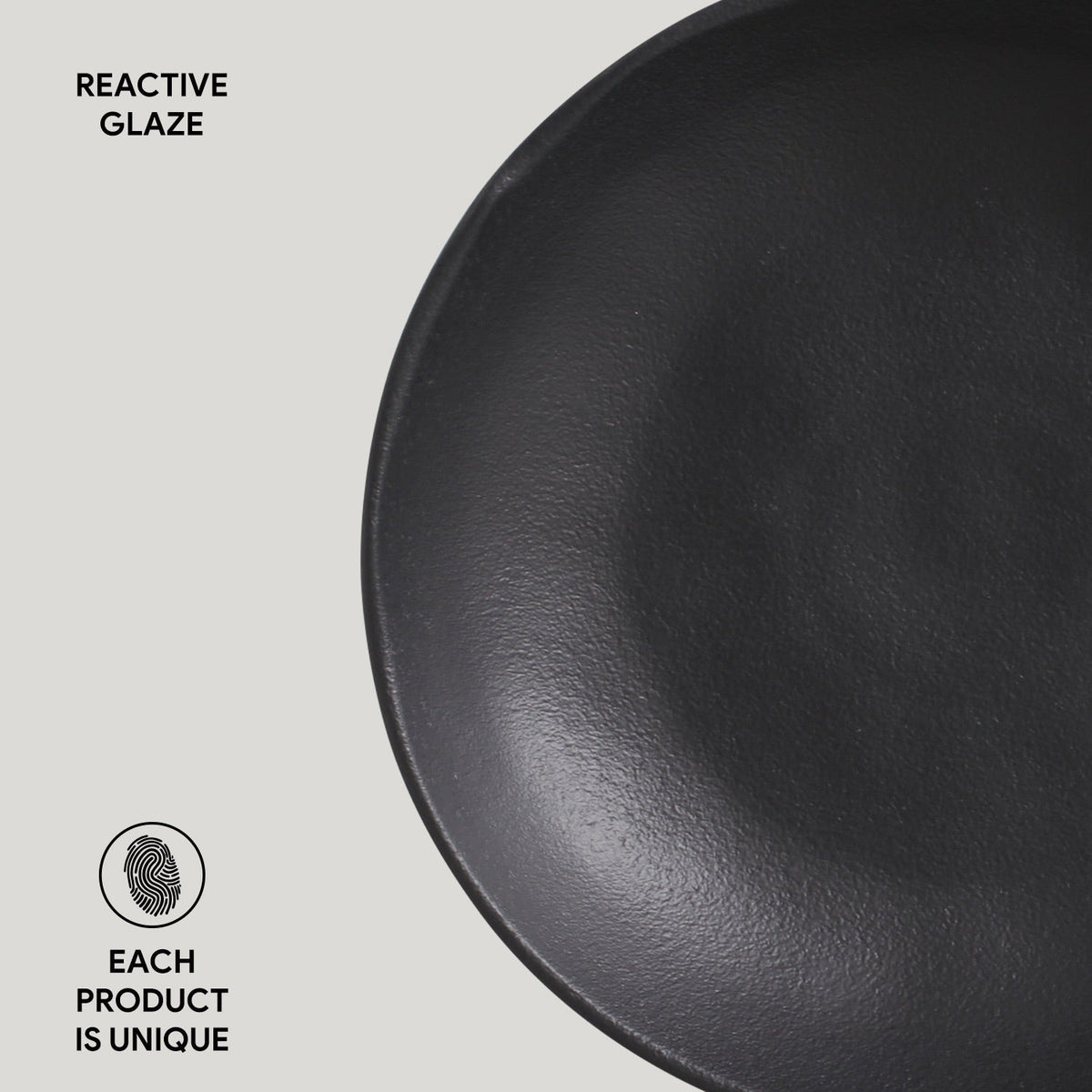 Black ceramic plate with 'Reactive Glaze' text and 'Each Product is Unique' label on a light gray background