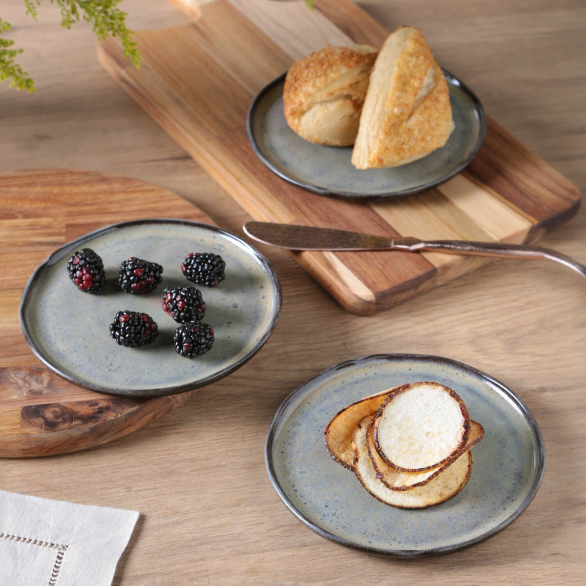 Three ceramic plates with food on a wooden table