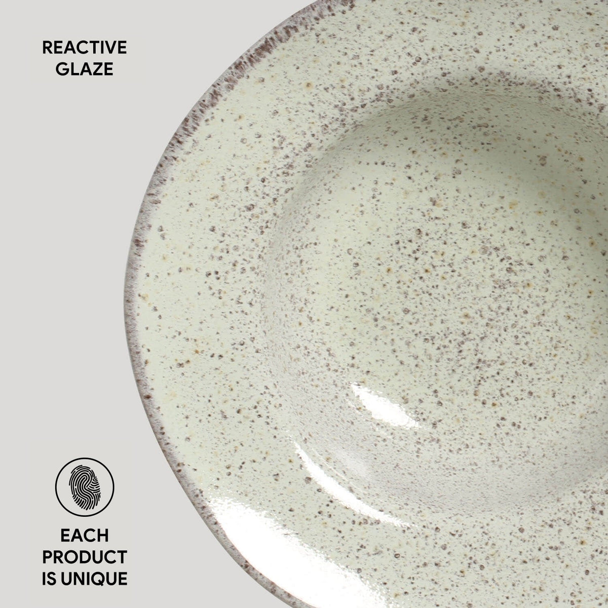 Ceramic bowl with reactive glaze on a light gray background