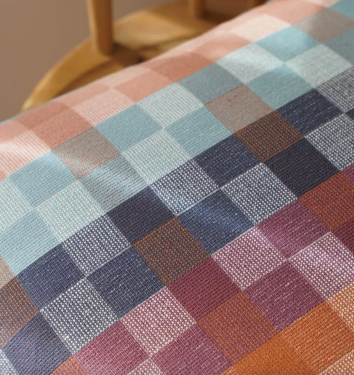 Multicolored checkered fabric on a wooden surface