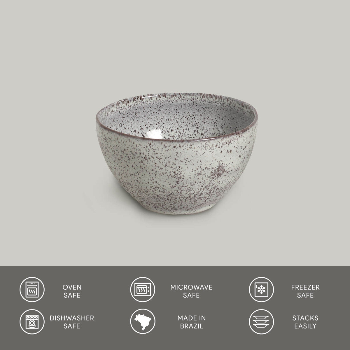 Speckled ceramic bowl on a gray background with safety and feature icons at the bottom.
