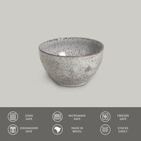Speckled ceramic bowl on a gray background with safety and feature icons at the bottom.