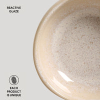 Close-up of a ceramic bowl with reactive glaze on a light gray background