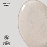 Close-up of a ceramic product with reactive glaze on a gray background