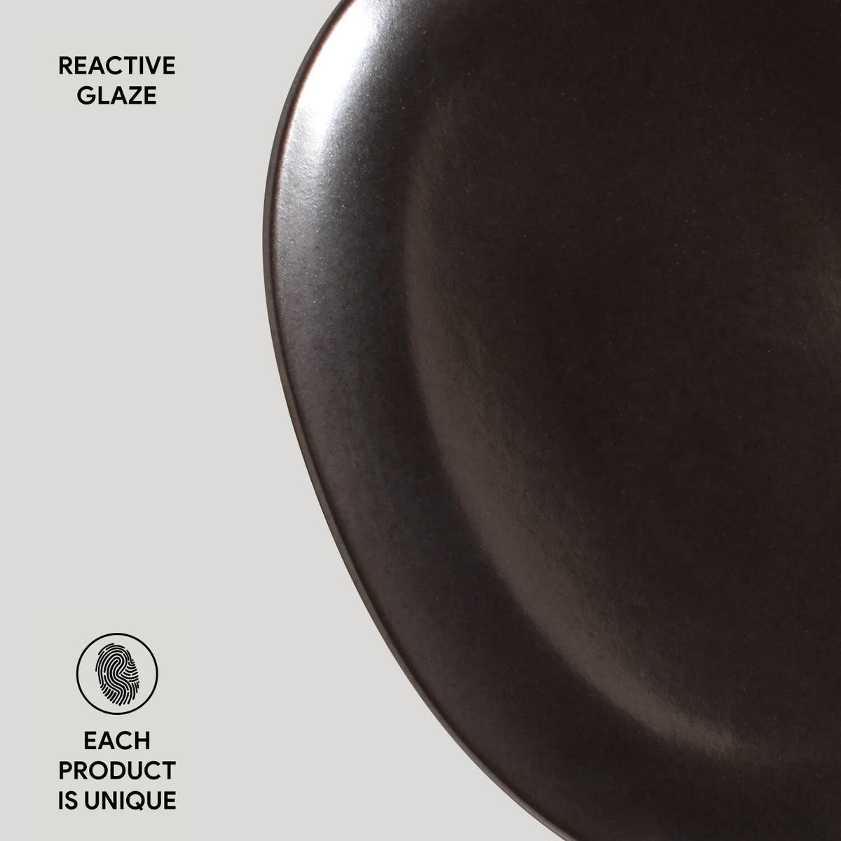Dark ceramic plate with 'Reactive Glaze' text and 'Each Product is Unique' label on a light gray background