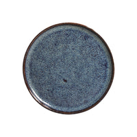 Round blue ceramic plate on a white background