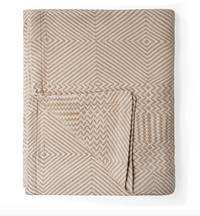 Textured blanket with geometric pattern on a white background