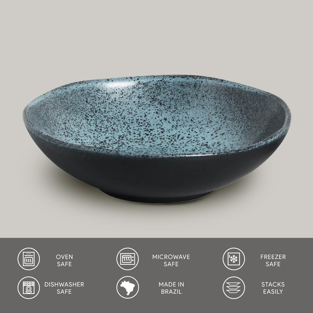Speckled blue and black ceramic bowl on a light gray background