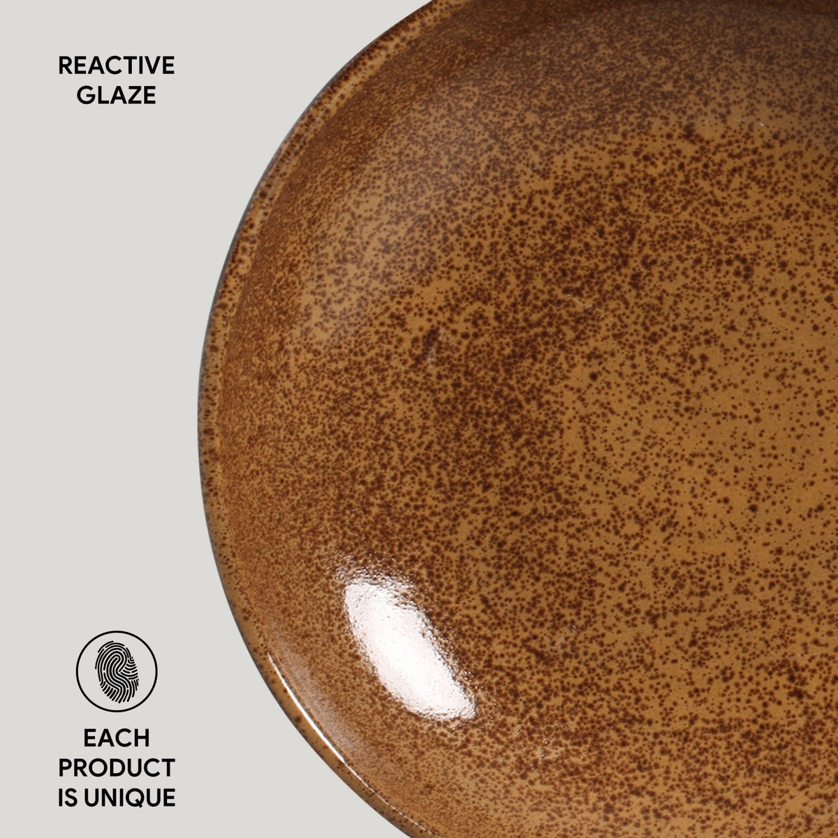 Close-up of a brown ceramic plate with reactive glaze texture on a light gray background.
