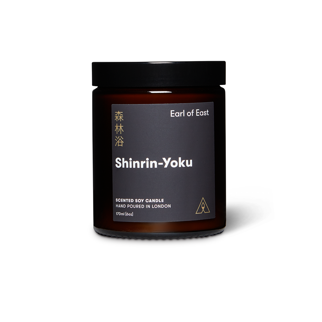 Dark jar scented soy wax candle with lid and label reading Earl of East Shinrin-Yoku
