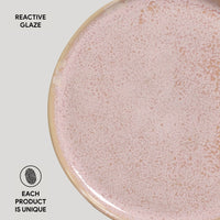 Close-up of a ceramic plate with reactive glaze on a light gray background