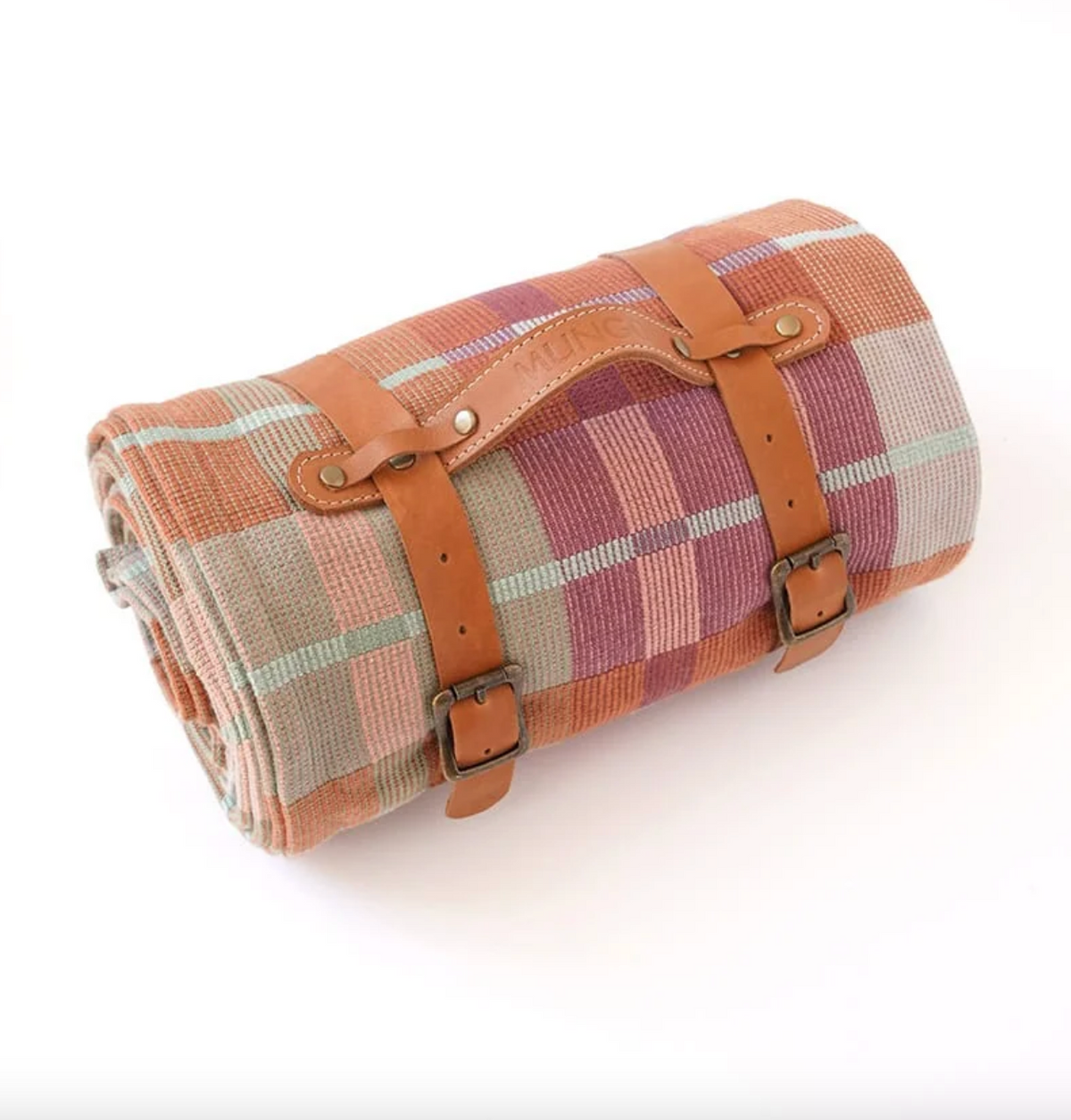 Roll-up picnic blanket with plaid pattern and brown straps on a white background