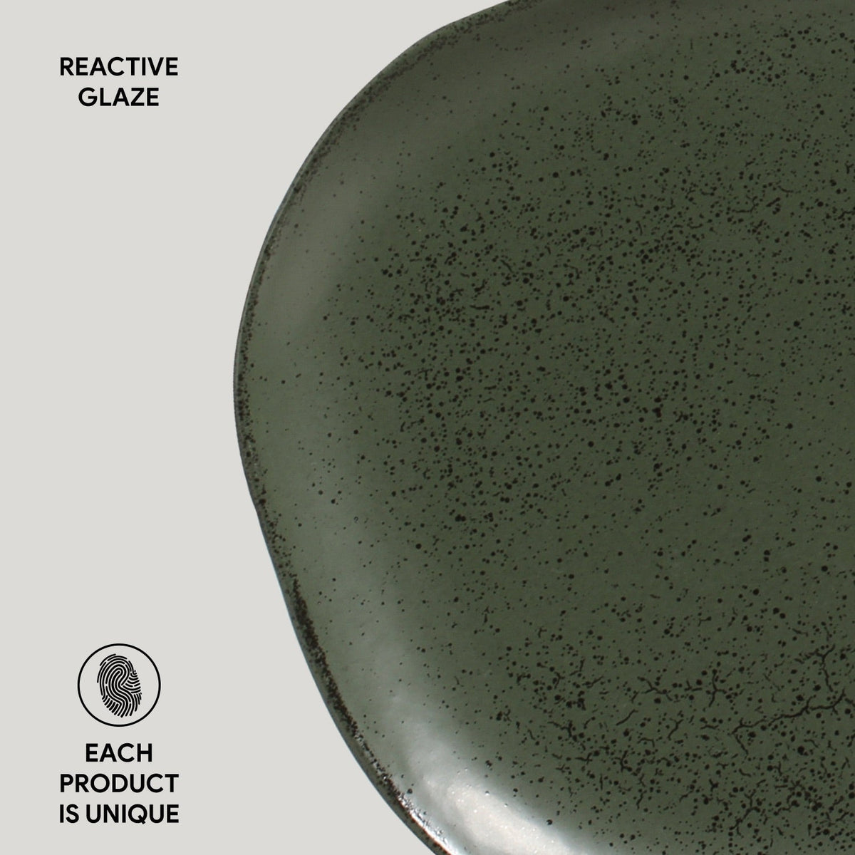 Green ceramic plate with reactive glaze on a light gray background