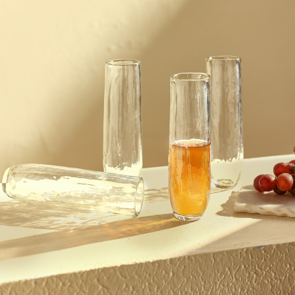 Set of 4 Pebbled Stemless Flute Glasses on a white surface