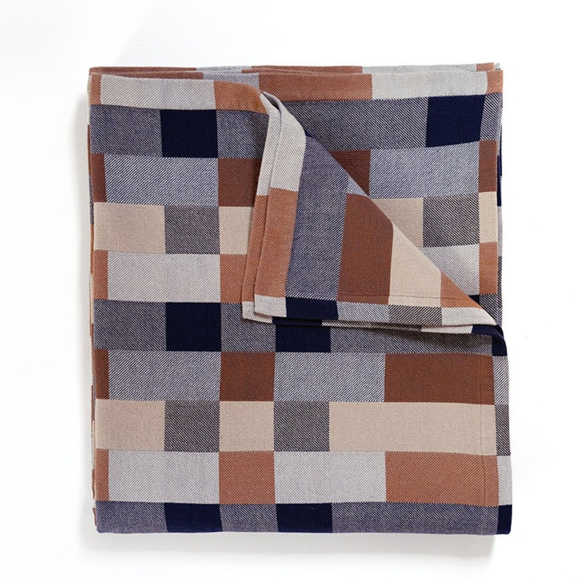 Folded blanket with a geometric pattern in neutral colors