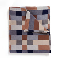 Folded blanket with a geometric pattern in neutral colors
