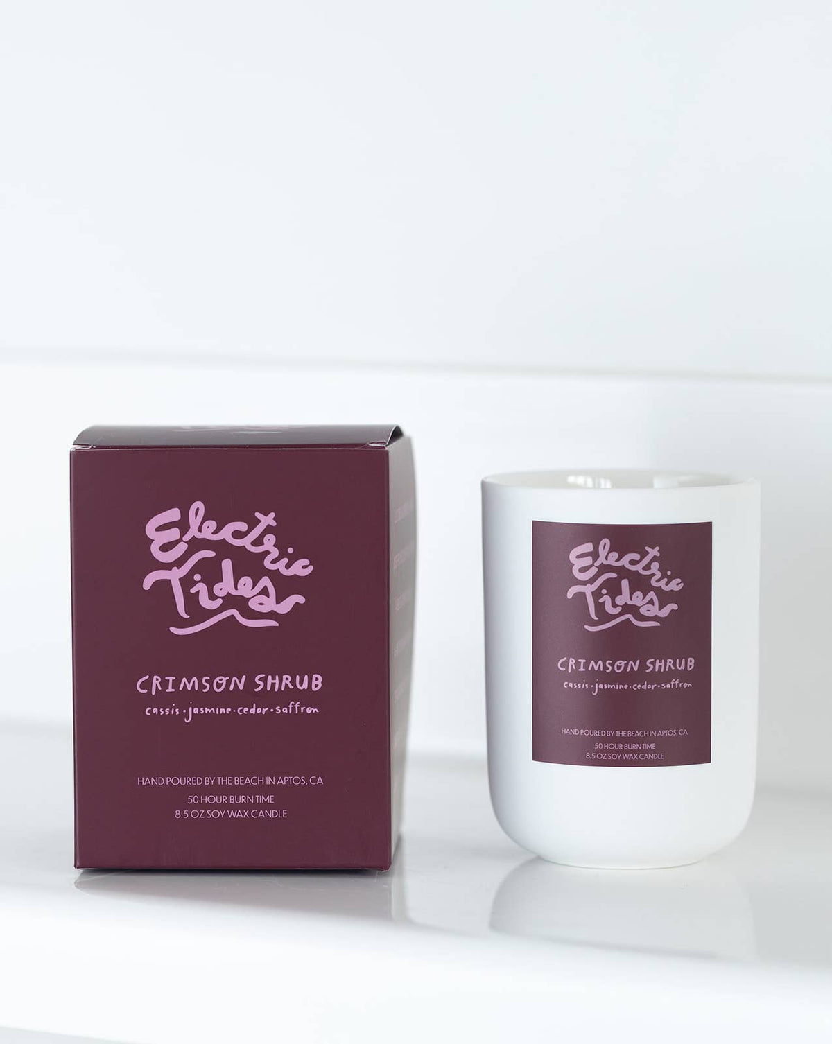 Candle and packaging of Electric Tides Crimson Shrub on a white background