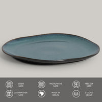 Teal ceramic plate on a gray background with safety and feature icons at the bottom.