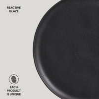 Black ceramic plate with 'Reactive Glaze' text and 'Each Product is Unique' label on a light gray background.