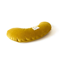 Mustard yellow pillow on a white background