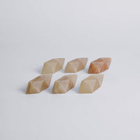 Set of six geometric stone shapes on a light gray background