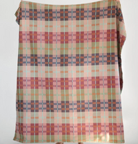 Multicolored checkered fabric draped over a surface on a white background