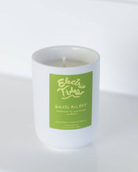 Candle with a green label on a white background