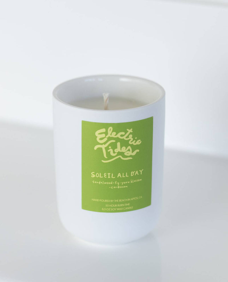 Candle with a green label on a white background