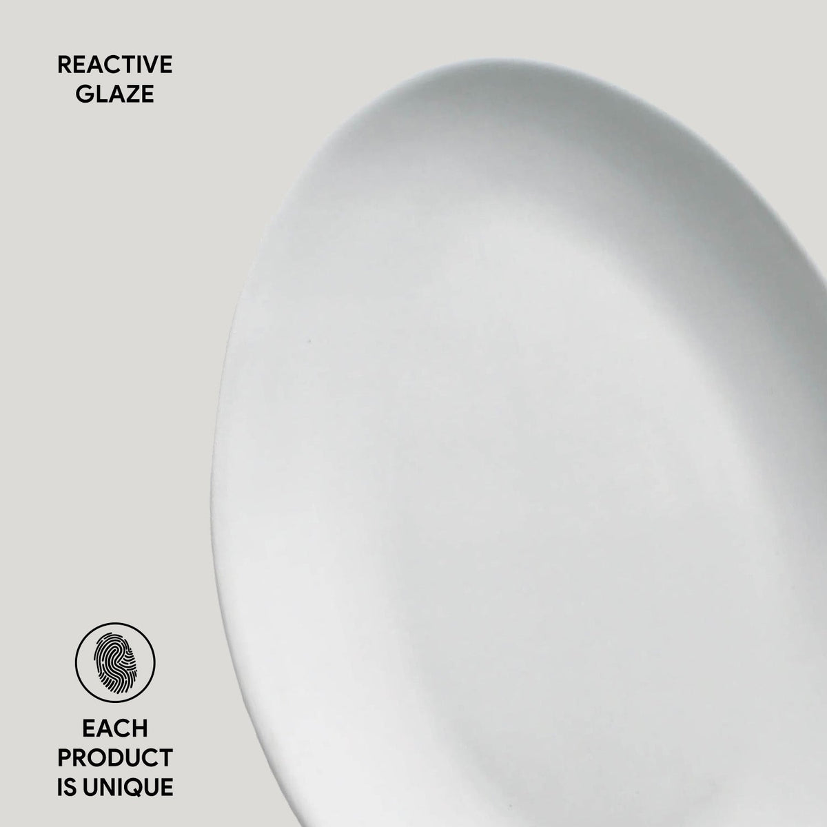 Close-up of a ceramic plate with 'Reactive Glaze' text and 'Each Product is Unique' label.