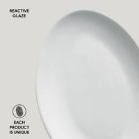 Close-up of a ceramic plate with 'Reactive Glaze' text and 'Each Product is Unique' label.