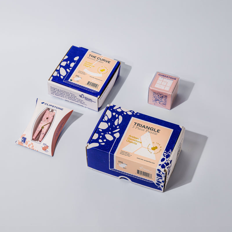 product packaging of stone objects including boxes and packets on a light gray background