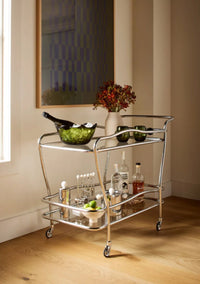 Serveware on a metal and glass bar cart