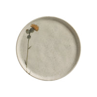 Round ceramic plate with a floral design on a white background