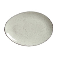 Oval ceramic plate with a speckled pattern on a white background