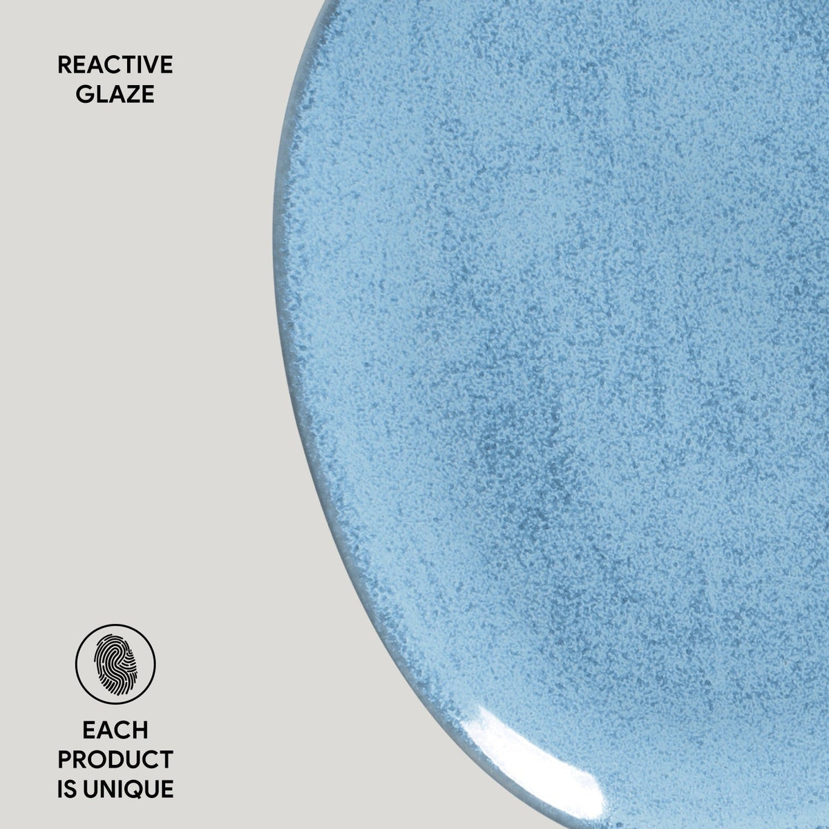 Close-up of a blue ceramic plate with reactive glaze on a light gray background