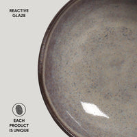 Ceramic plate with reactive glaze on a light gray background