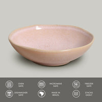 Pink ceramic bowl on a gray background with safety and feature icons at the bottom.