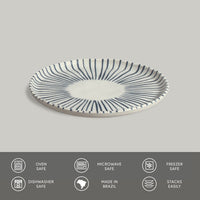 Ceramic plate with striped design on a gray background