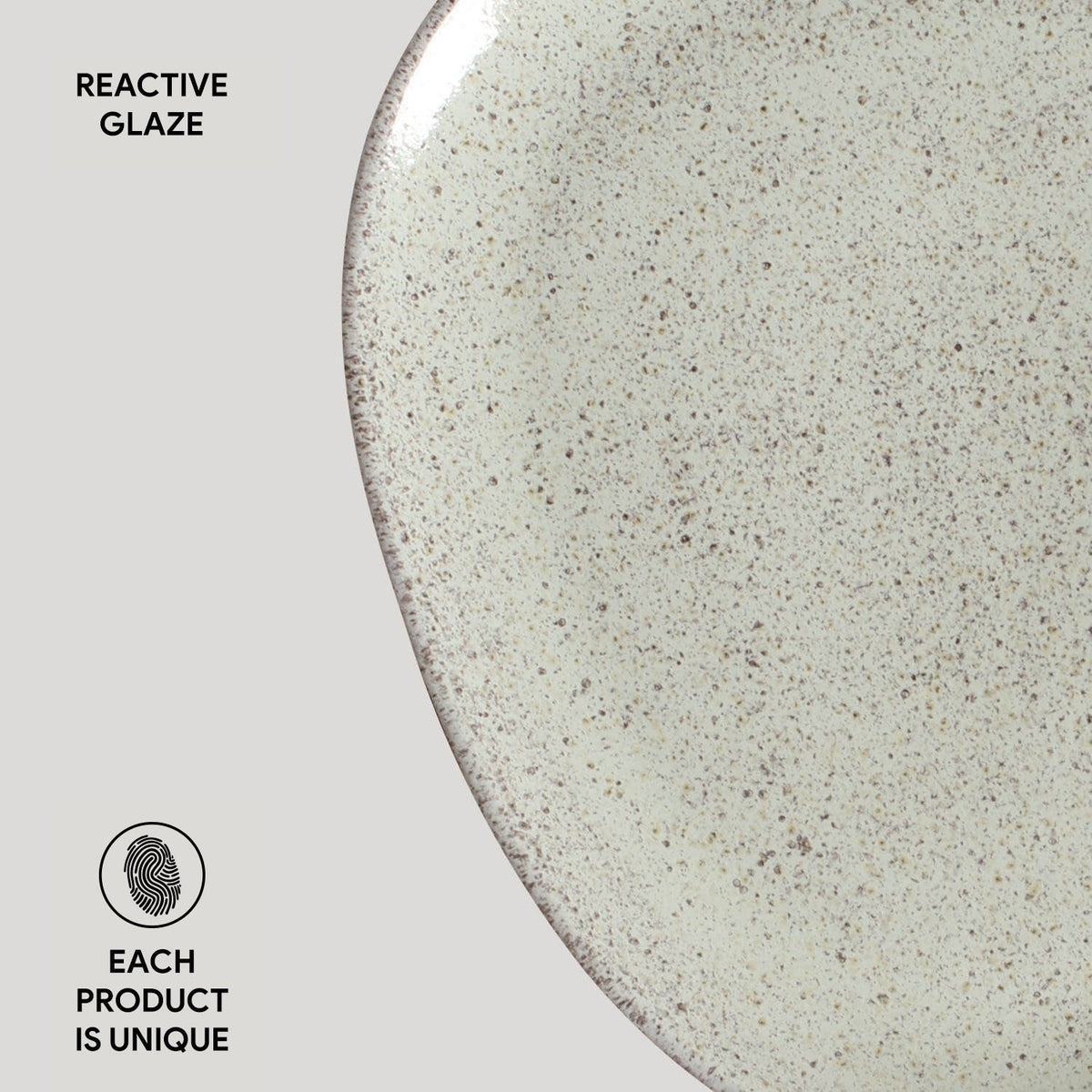 Close-up of a ceramic plate with reactive glaze on a light gray background