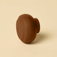 Brown circular object on a beige background