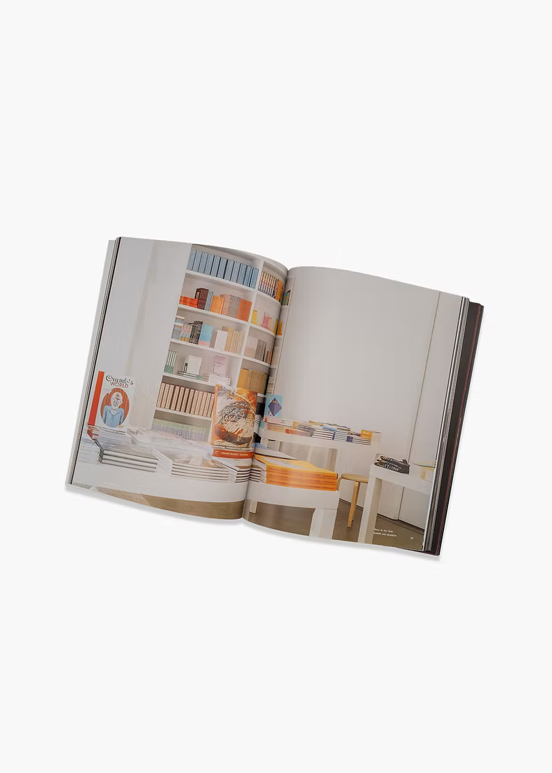 Open book displaying interior design images on a white background